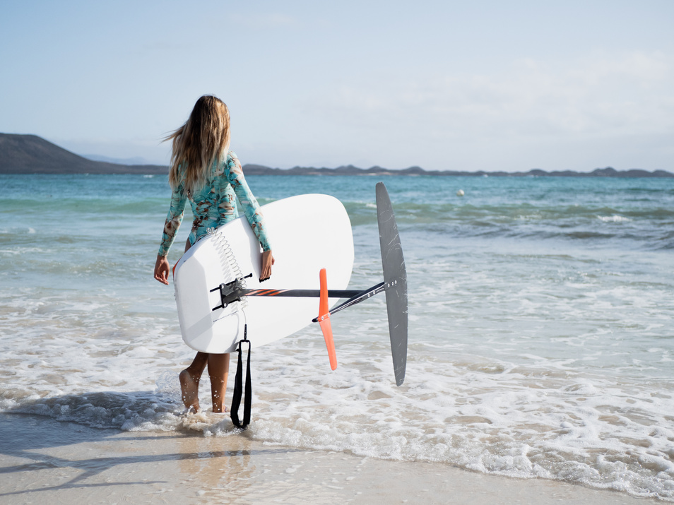 Hydrofoil surfer woman on the beach